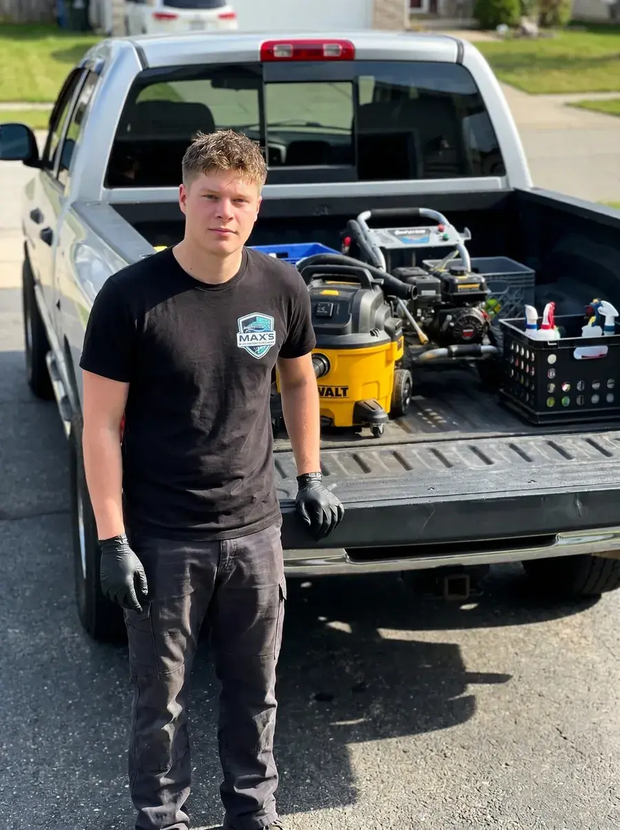 Max — owner of Max's Essential Detailing — standing in front of his fully-loaded detail truck